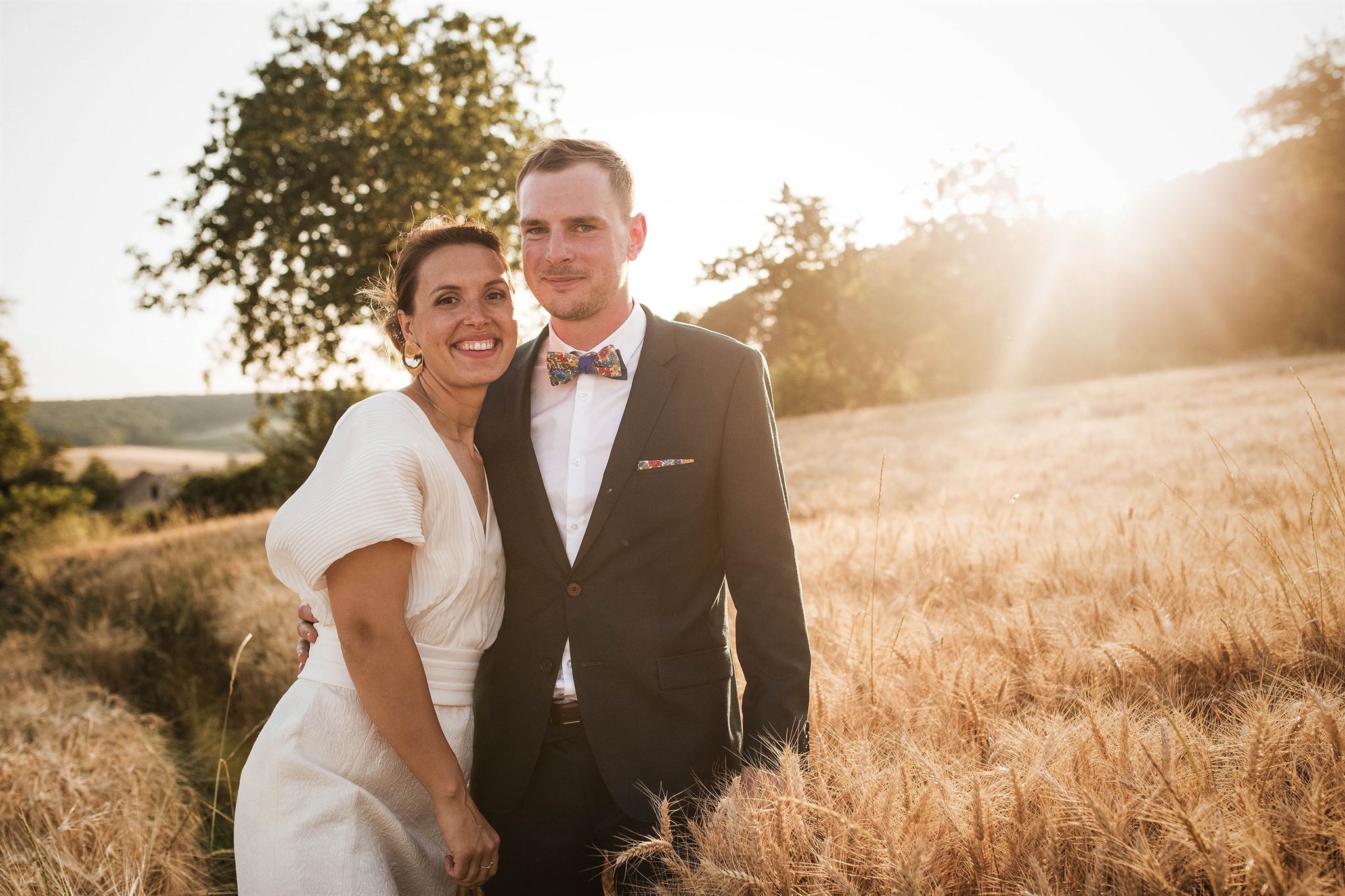 The couple in a wheatfield at sunset after a château wedding in Burgundy