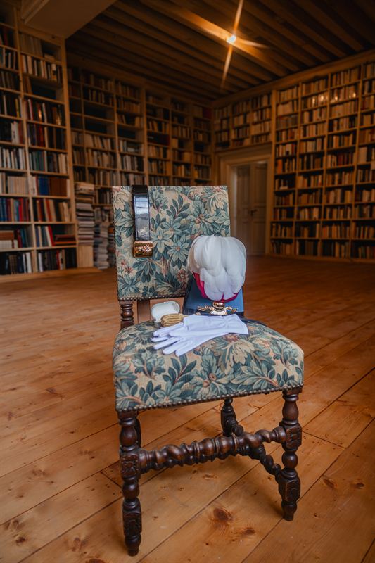Ceremonial uniform and cap laid on an antique chair