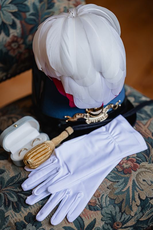 Cap, white gloves and wedding rings before the ceremony