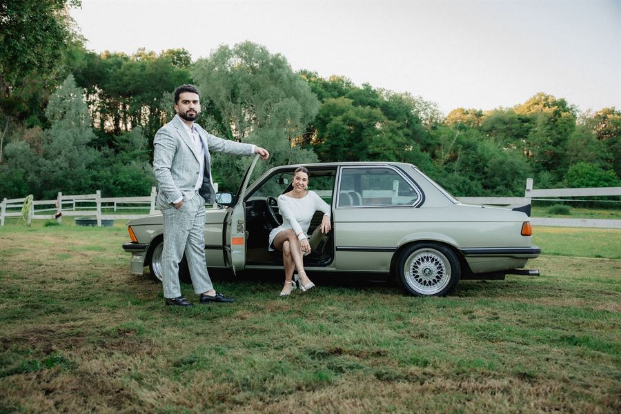 The couple beside a vintage BMW in the evening light